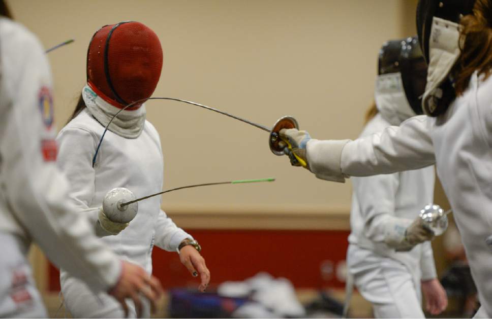 Francisco Kjolseth  |  The Salt Lake Tribune
Carina Fung, 15, allows herself to be the target as young fencers learn different ways to hit from olympians during the USA Fencing National Championships in Salt Lake City on Friday, July 7, 2017. More than 4,000 athletes from around the globe are competing.