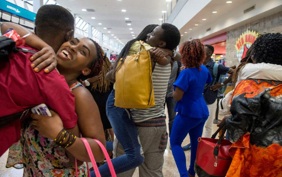 Leah Hogsten  |  The Salt Lake Tribune
Gustav Nyangabo hugs his sister Evelyne Gaju (center) moments after the arrival of Gaju and Nyangabo's mother and four other siblings from the Democratic Republic of Congo. The Salt Lake City office of the International Rescue Committee welcomed the last refugee family to Utah on Thursday,  July 6, 2017, before President Donald Trump's 120-day ban on refugees goes into effect.