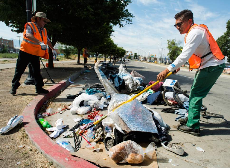 Rick Egan  |  The Salt Lake Tribune

Jorge Mendez, right, of the Salt Lake County Health Department, cleans up trash left by homeless campers on 500 West in Salt Lake City on Thursday, July 6, 2017. The health department does a cleanup in the area every other week or so. The biggest challenge for crews is the disposal of syringes discarded by drug users.