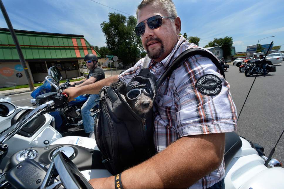 Scott Sommerdorf   |  The Salt Lake Tribune  
A rider takes a well-outfitted passenger along with him on the first annual Utah 1033 Ride, Sunday, July 9, 2017. The event honors those who made the ultimate sacrifice while serving in the line of duty. The event is named after The Utah 1033 Foundation, a local non-profit dedicated to providing immediate financial support to families of Utah's fallen law enforcement officers.
