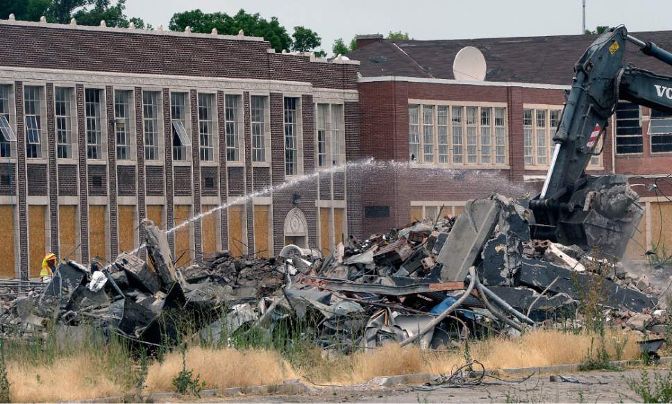 Al Hartmann  |  The Salt Lake Tribune
Demolition has begun on Granite High School Monday July 10 in Soth Salt Lake.  Construction workers have demolished the swimming pool and auxiliary gym on the south end of the site and are working on tearing down the east auditorium and cafeteria building.