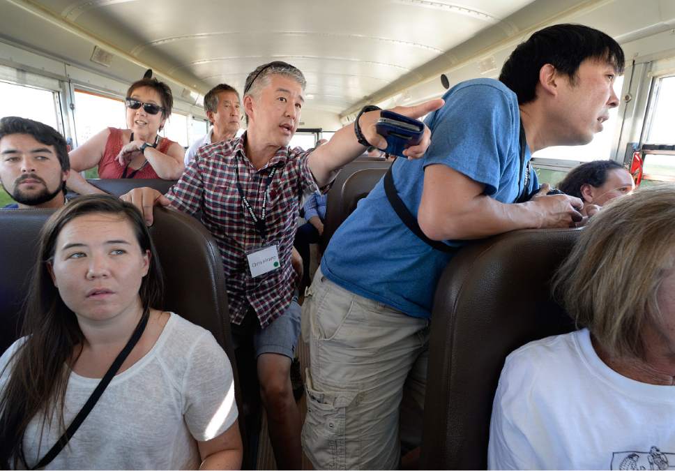 Scott Sommerdorf   |  The Salt Lake Tribune  
Chris Hirano, center, points out the Topaz Interment Camp where his father, 83 year-old Bobby Hirano, was held as a boy during WWII. The Hirano family was taking a bus trip out to the site of the camp outside Delta on Saturday.