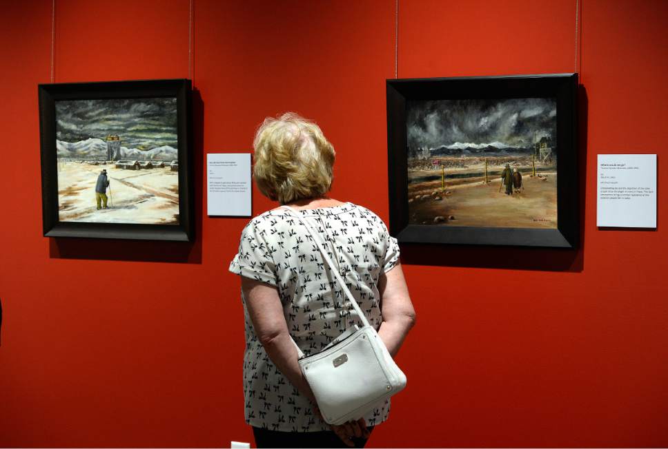 Scott Sommerdorf   |  The Salt Lake Tribune  
A visitor to the grand opening of the Topaz Museum in Delta, spends some time with two of the more somber paintings depicting life in the internment camp, Saturday, July 8, 2017.