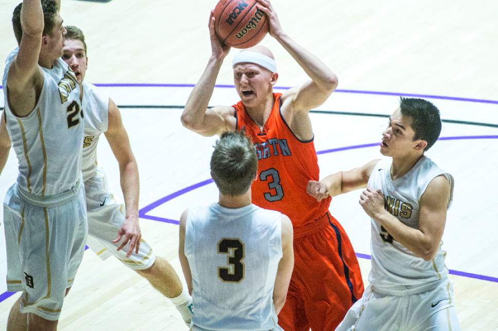 Chris Detrick  |  The Salt Lake Tribune
Brighton's Brock Miller (3) tries to shoot past Davis' Landon Swartz (3) and Davis' Tony Feick (5) during the 5A semifinal game at the Dee Events Center Friday February 27, 2015.  Brighton defeated Davis 64-62.