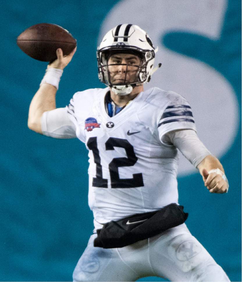 Rick Egan  |  The Salt Lake Tribune

Brigham Young quarterback Tanner Mangum (12) throws a pass for the Cougars, at BYU defeated Wyoming 24-21in the Poinsettia Bowl, at Qualcomm Stadium in San Diego, December 21, 2016.