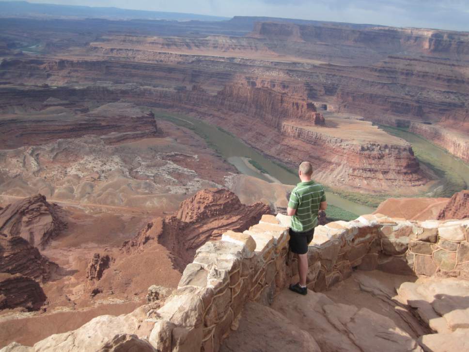 Tribune file photo

A tourist enjoys the view from Dead Horse Point State Park near Moab.
