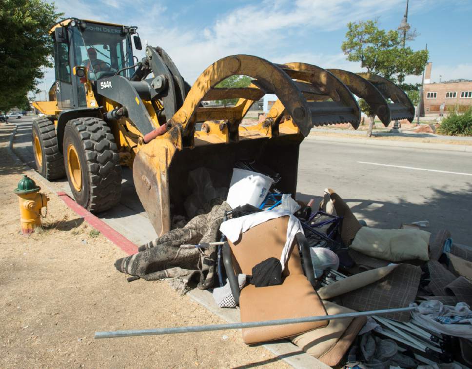 Rick Egan  |  The Salt Lake Tribune

Heavy machinery picks up trash left by homeless campers in the Rio Grande area of Salt Lake City, during the Salt Lake County Health Department's cleanup on Thursday, July 6, 2017. The biggest challenge for crews is the disposal of syringes discarded by drug users.
