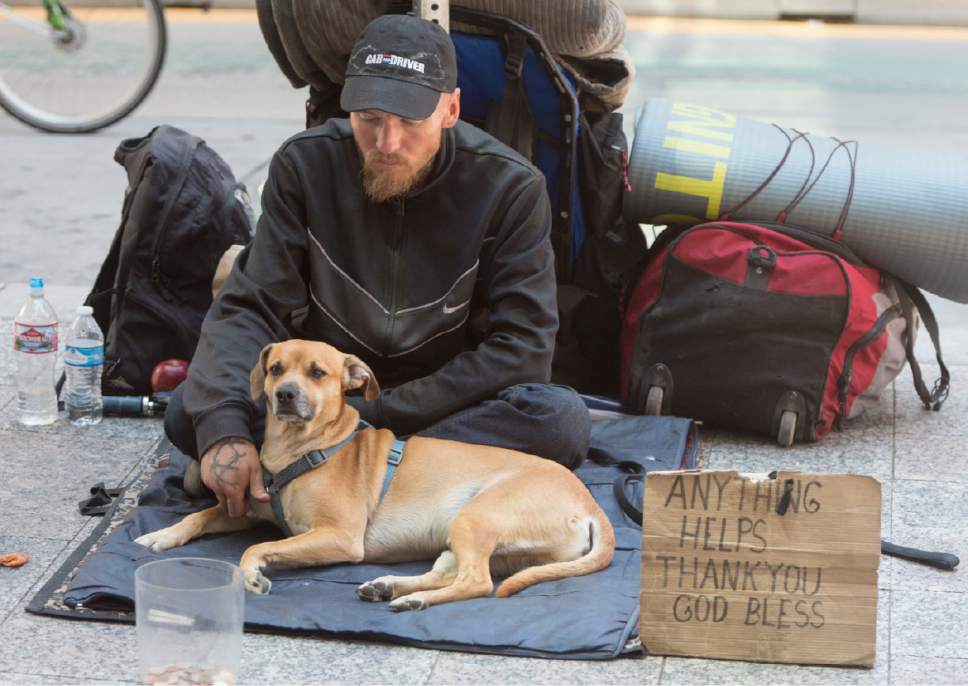 Rick Egan  |  The Salt Lake Tribune

A man and his dog sit on the sidewalk beg for money outside the City Creek Center, Thursday, July 13, 2017.
