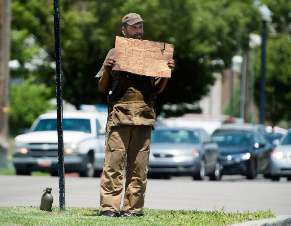 Rick Egan  |  The Salt Lake Tribune

A man holds a cardboard sign on 400 West and 400 South, in Salt Lake, Thursday, July 13, 2017.
