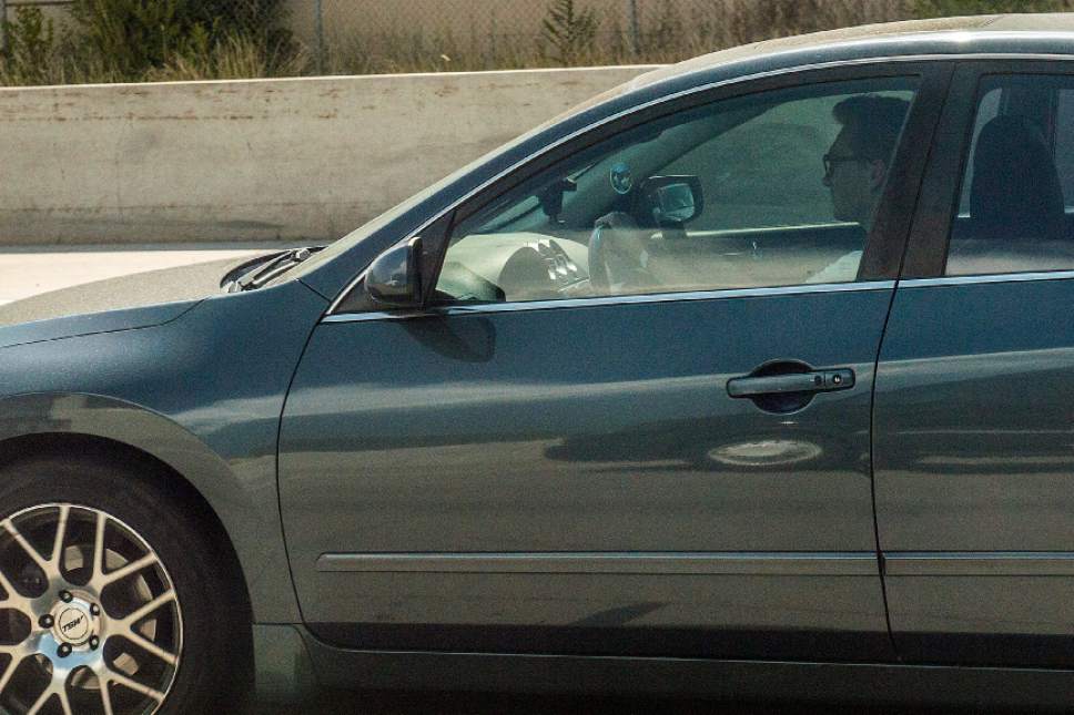 Chris Detrick  |  The Salt Lake Tribune
A driver uses his cellphone while driving on Interstate 15 Thursday, July 13, 2017.