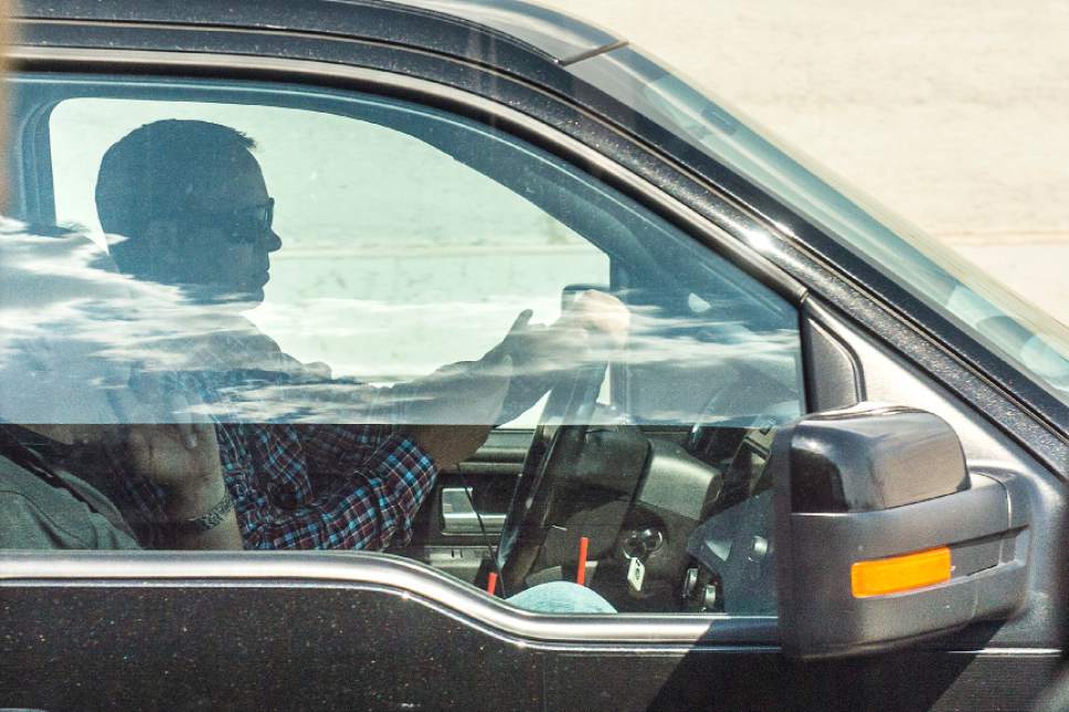 Chris Detrick  |  The Salt Lake Tribune
A driver uses his cellphone while driving on Interstate 15 Thursday, July 13, 2017.