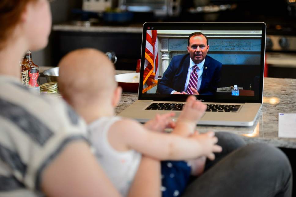 Trent Nelson  |  The Salt Lake Tribune
Katie Matheson, holding her 9-month-old son Abraham, watches Sen. Mike Lee's health care tele-town hall in South Jordan, Wednesday July 12, 2017.