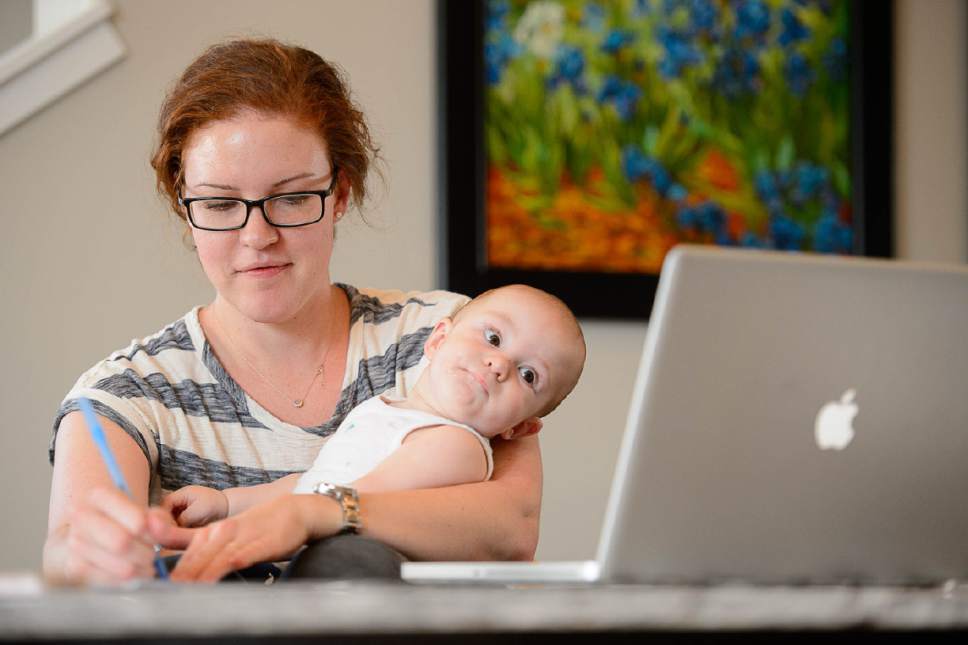 Trent Nelson  |  The Salt Lake Tribune
Katie Matheson, holding her 9-month-old son Abraham, watches Sen. Mike Lee's health care tele-town hall in South Jordan, Wednesday July 12, 2017.