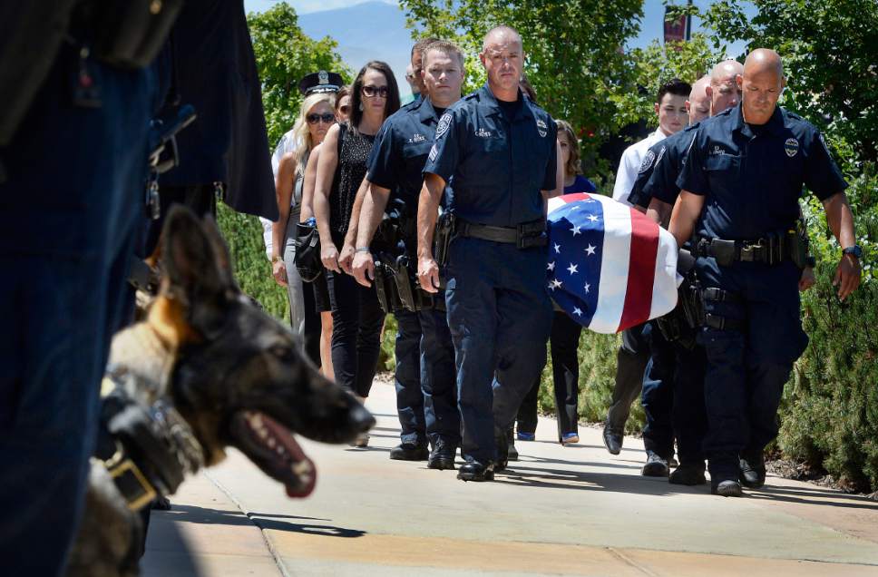 Scott Sommerdorf   |  The Salt Lake Tribune  
Sgt. Chad Reyes, center, and pall bearers take "Dingo," a Unified Police Department dog shot and killed in the line of duty July 6 while working to apprehend a suspect on July 6th. Sgt. Reyes was Dingo's handler, and was promoted to Lieutenant by Sheriff Jim Winder during the ceremony, Saturday, July 15, 2017.