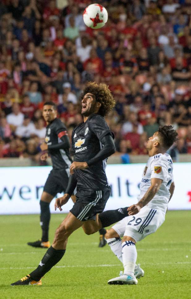 Rick Egan  |  The Salt Lake Tribune

Real Salt Lake midfielder Jose Hernandez (29) goes for the ball along with Manchester United midfielder Marouane Fellaini (27), as Real Salt Lake played Manchester United in a friendly game at Rio Tinto Stadium, Monday, July 17, 2017.