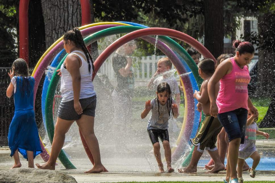 Chris Detrick  |  The Salt Lake Tribune

Children play in the splash pad in Rotary Playground at Liberty Park on Wednesday, July 12, 2017.