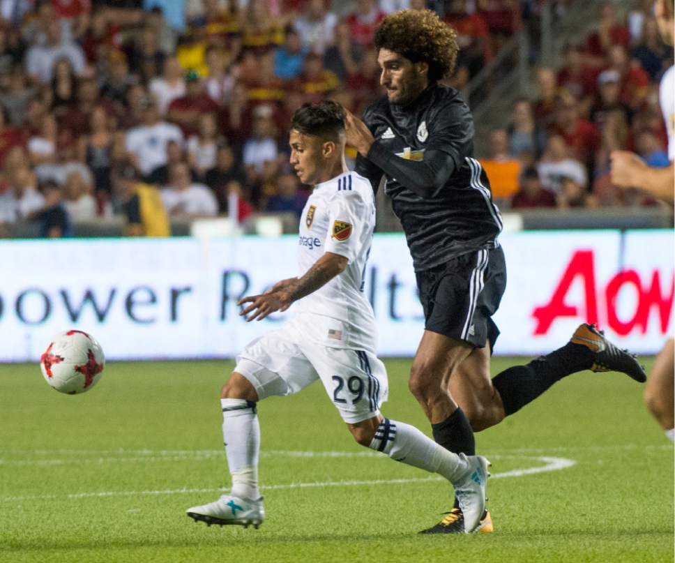 Rick Egan  |  The Salt Lake Tribune

Real Salt Lake midfielder Jose Hernandez (29) goes for the ball along with Manchester United midfielder Marouane Fellaini (27), as Real Salt Lake played Manchester United in a friendly game at Rio Tinto Stadium, Monday, July 17, 2017.