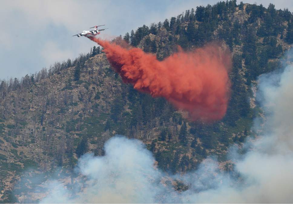 Scott Sommerdorf   |  The Salt Lake Tribune  
Aerial crews fight the fires being driven uphill as seen from Creekside Park in Alpine, Sunday, July 16, 2017.