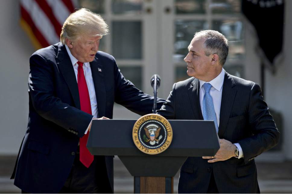 EPA Administrator Scott Pruitt (right) shakes hands with President Donald Trump in the Rose Garden of the White House in Washington on June 1, 2017. MUST CREDIT: Bloomberg photo by Andrew Harrer.