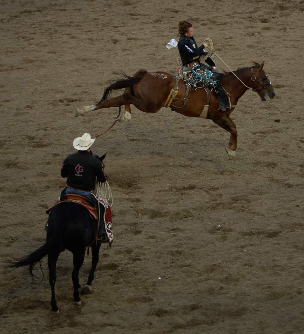 Francisco Kjolseth | The Salt Lake Tribune
Ryder Wright of Milford, UT, pulls in a score of 75.00 in the championship saddle bronc competition in the new 10,000-seat Fairpark Arena on day two of the Days of '47 Rodeo in its new home in Salt Lake City on Thursday, July 20, 2017.