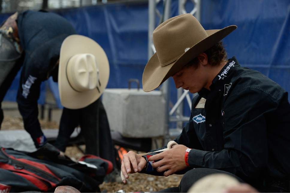 Francisco Kjolseth | The Salt Lake Tribune
Ryder Wright of Milford, UT, wraps his hands as he prepares for the championship saddle bronc riding competition at Fairpark Arena on day two of the Days of '47 Rodeo in its new home in Salt Lake City on Thursday, July 20, 2017.