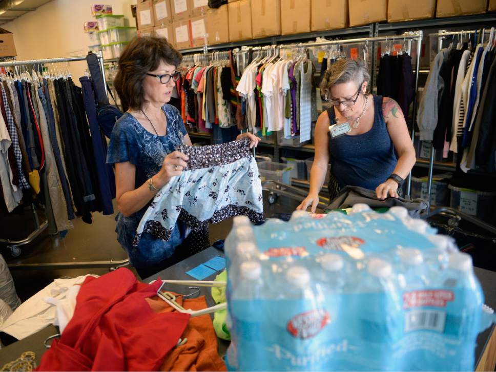 Al Hartmann  |  The Salt Lake Tribune
Volunteers Kathy Wagner, left, and Julie DeLay sort donated summer clothing for  Volunteers of America, Utah homeless outreach workers to give  to people on the street. With temperatures reaching the triple digits, Volunteers of America is asking for donations of bottled water to help homeless people stay hydrated. The nonprofit also is collecting sunscreen, Gatorade and summer clothing.