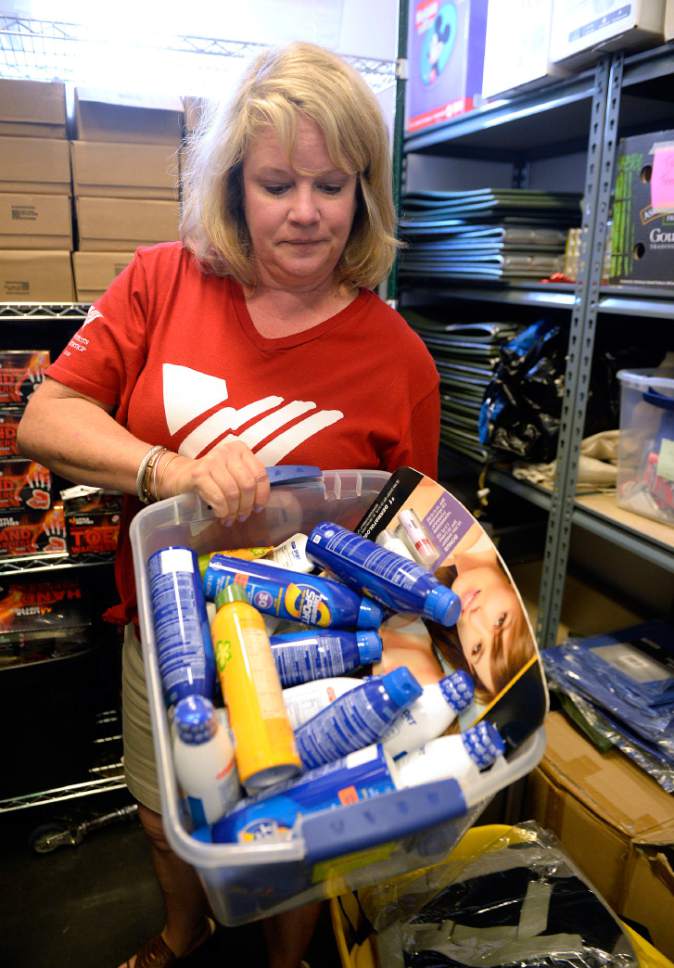 Al Hartmann  |  The Salt Lake Tribune
Jayme Anderson, of  Volunteers of America, Utah, checks the supply of donated sunscreen for outreach workers to give to people on the street.  With temperatures reaching the triple digits, Volunteers of America is asking for donations of bottled water to help homeless people stay hydrated. The nonprofit also is collecting sunscreen, Gatorade and summer clothing.