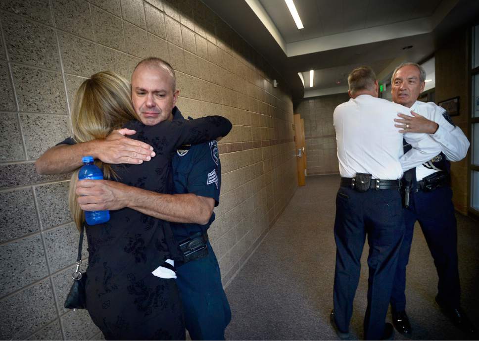 Scott Sommerdorf   |  The Salt Lake Tribune  
Sgt. Chad Reyes, left, gets a hug from Shawn Winder, Sheriff Jim Winder's wife prior to the memorial service for "Dingo," a Unified Police Department dog shot and killed in the line of duty July 6 while working with his K-9 handler Sgt. Chad Reyes, Saturday, July 15, 2017.