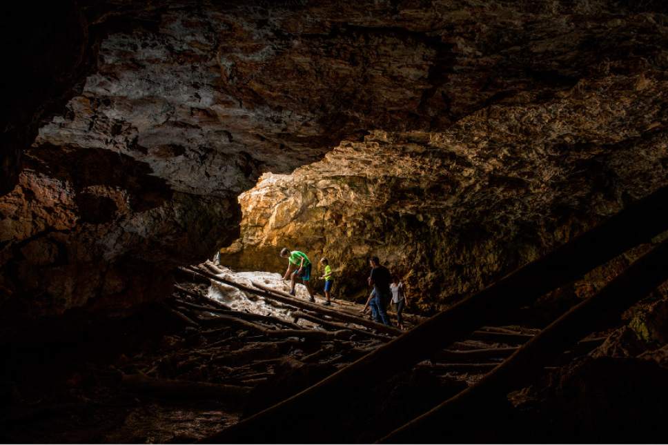 Leah Hogsten  |  The Salt Lake Tribune
Visitors to Duck Creek Ice Cave slip on an ice bank near the entrance to the cave July 15, 2017 as they try to exit the cave. Duck Creek Ice Cave measures about 60 feet by 40 feet, with a ceiling height of 15 feet high. The ice cave is located in Tertiary limestone deposits that are 30 to 50 million years old. Winter ice and snow melts in the warmer months, although even on a hot summer day, the floor temperature is just above freezing.