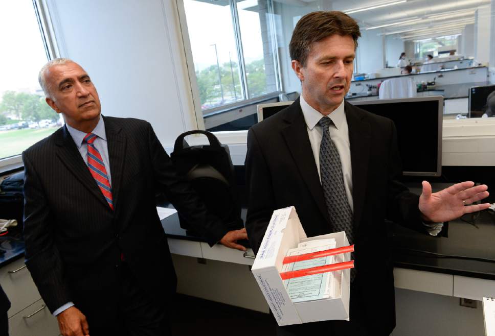 Francisco Kjolseth | The Salt Lake Tribune
Salt Lake County District Attorney Sim Gill, left, and DPS Crime Lab director Jay Henry talk about the strides made in processing rape kits like the one Henry was holding following a news conference that introduced the Sexual Assault Kit Initiative (SAKI) group. The Commission on Criminal and Juvenile Justice and the Utah Department of Public Safety have established a group dedicated to pursuing justice for victims of sexual assault. That group includes a new victim advocate who will be the point of contact for victims seeking resources and the status of their sexual assault kit.