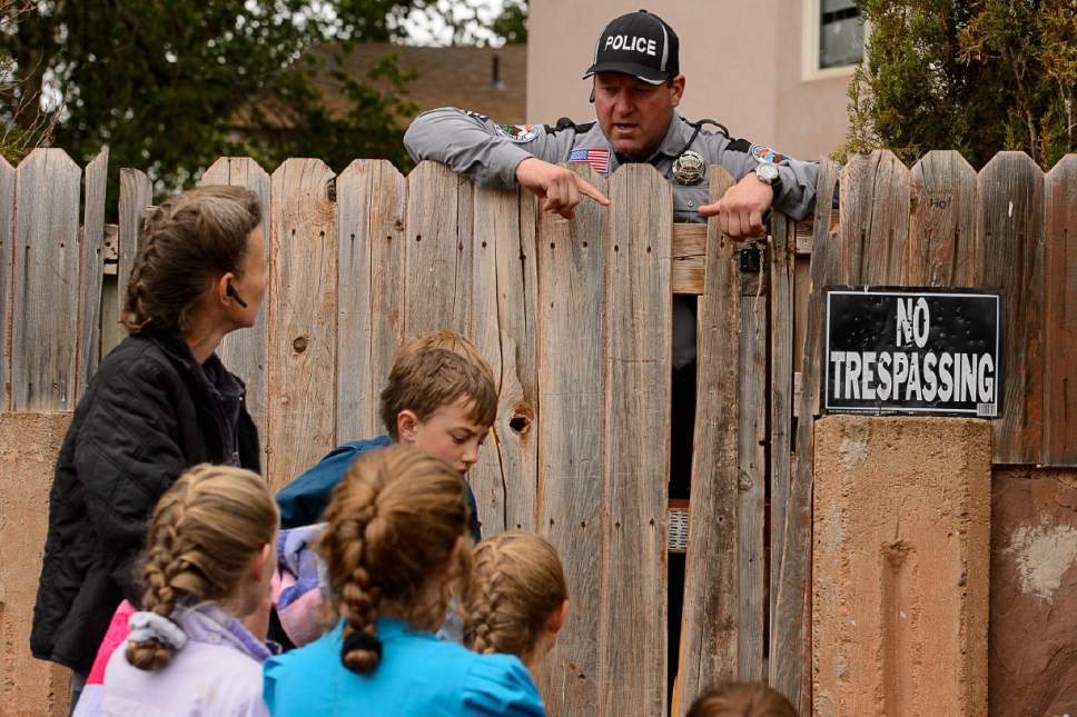 Trent Nelson  |  The Salt Lake Tribune
Colorado City Town Marshal Sam Johnson tells an FLDS woman who had been evicted from her Colorado City, AZ, home, that she will be allowed to retrieve her belongings from the yard, Wednesday May 10, 2017.