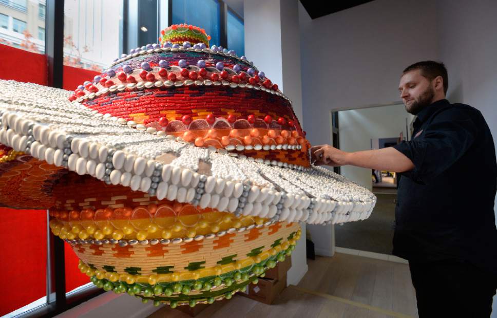 Al Hartmann  |  The Salt Lake Tribune
 Macy's City Creek visual manager Chad Young works on elaborate Christmas ornament made of thousands of individual pieces of candy, In this archive photo from 2014. The spinning ornament weighed about 150 pounds.