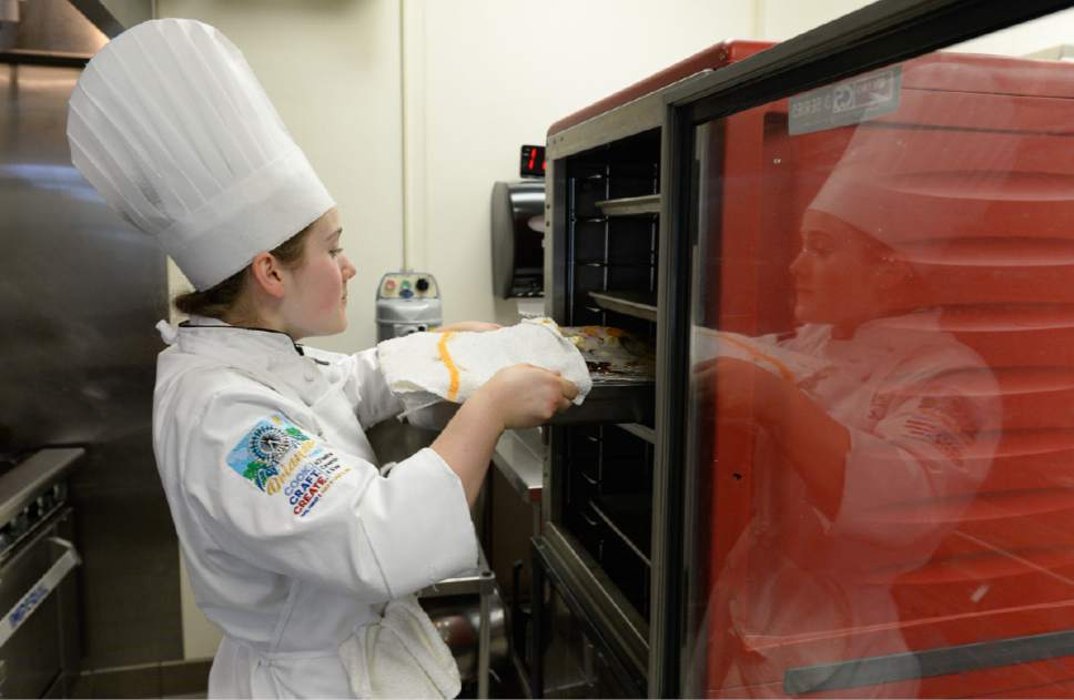 Francisco Kjolseth | The Salt Lake Tribune
Culinary student Madeline Black pulls a pork tenderloin from the warmer oven to add the final touches as the 19 year old student works an event through the student run restaurant called Restaurant Forte recently.