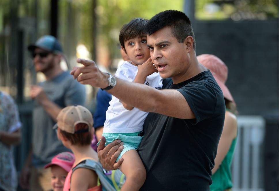 Scott Sommerdorf   |  The Salt Lake Tribune  
Race car driver Nur Ali, points out parts of the Strider course to his son Pasha who will compete later at the Strider World Championships, held at the Gallivan Center, Saturday, July 22, 2017.