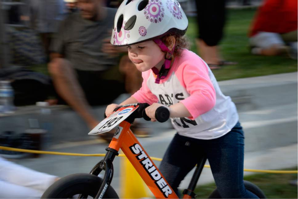 Scott Sommerdorf   |  The Salt Lake Tribune  
Two year old Elsie Stone, from Lehi, gives her racing all her attention during open course warm up laps prior to the Strider World Championships, held at the Gallivan Center, Saturday, July 22, 2017.
