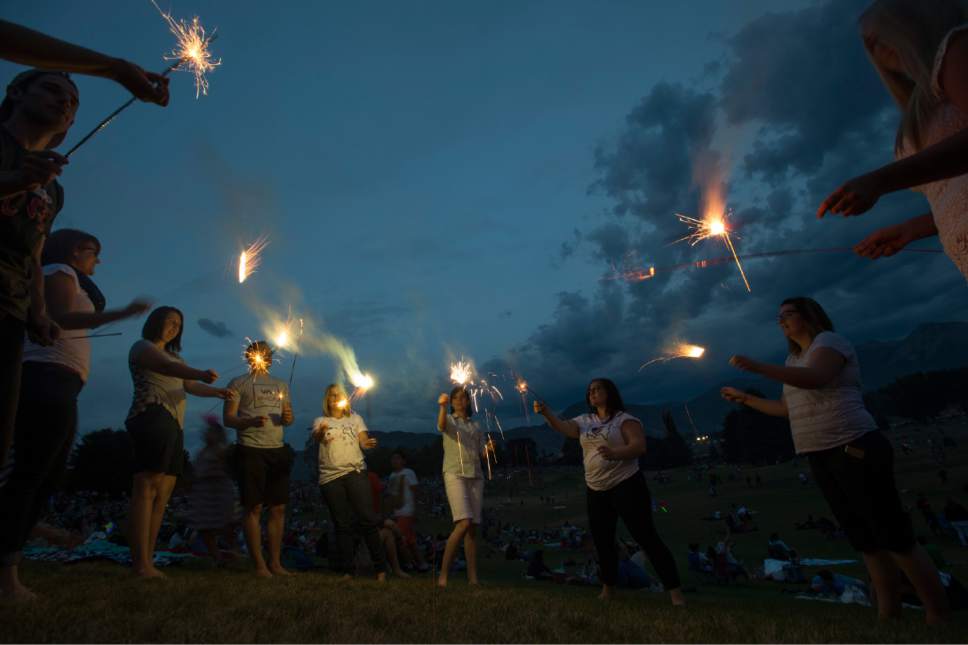 Rick Egan  |  Tribune file photo
Revelers play with sparklers before the Sugar House fireworks on July 4, 2015. Due to the impact of fireworks on air quality, Donna Spangler, a spokeswoman for the Department of Environmental Quality, suggested residents skip individual or neighborhood fireworks this year in favor of large commercial or community displays.