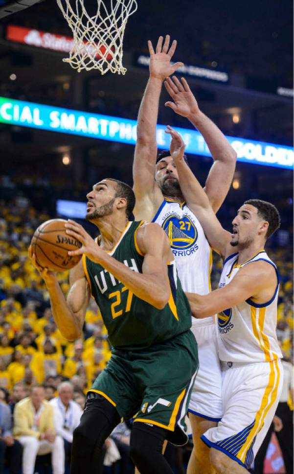 Steve Griffin  |  The Salt Lake Tribune


Utah Jazz center Rudy Gobert (27) is covered by Golden State Warriors center Zaza Pachulia (27) and Clay Thompson during NBA playoff game between the Utah Jazz and the Golden State Warriors at Oracle Arena in Oakland Tuesday May 2, 2017.