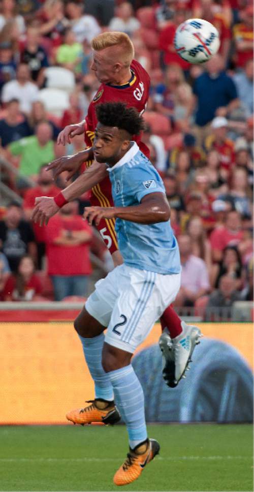 Michael Mangum  |  Special to the Tribune

Sporting Kansas City defender Erik Palmer-Brown (2) and Real Salt Lake defender Justen Glad (15) battle in the air for a header during their match at Rio Tinto Stadium in Sandy, UT on Saturday, July 22, 2017.