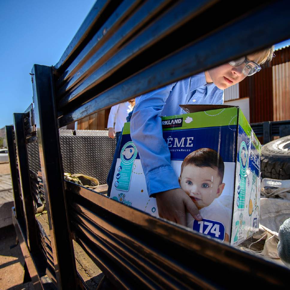 Trent Nelson  |  The Salt Lake Tribune
10-year-old Ammon Owen loads donations to deliver to needy members of the FLDS polygamous sect in Colorado City, Ariz., Saturday July 15, 2017. Owen and the Davis County Cooperative Society have been offering service and donations to needy FLDS members who were evicted from UEP homes in Hildale and Colorado City, Ariz.