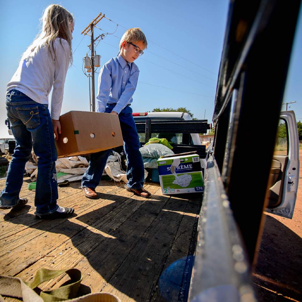 Trent Nelson  |  The Salt Lake Tribune
Kathrynn and Ammon Owen load donations to deliver to needy members of the FLDS polygamous sect in Colorado City, Ariz., Saturday July 15, 2017. Owen and the Davis County Cooperative Society have been offering service and donations to needy FLDS members who were evicted from UEP homes in Hildale and Colorado City, Ariz.