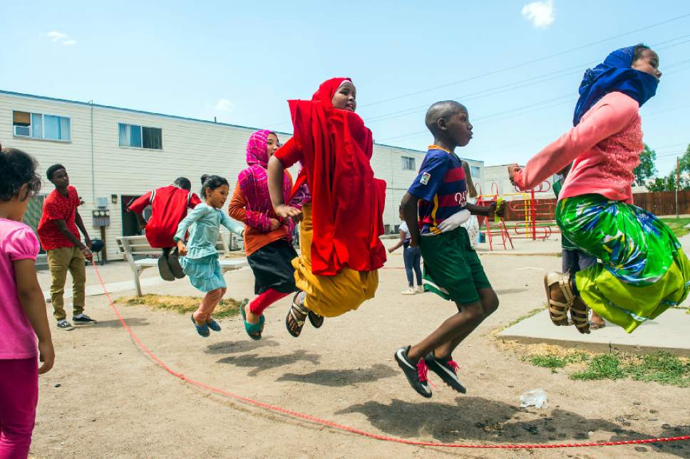 Chris Detrick  |  The Salt Lake Tribune
Promise Prevention Specialists Said Mohamed, left, swings the rope as Innocent Byiringiro, 11, Zahra Barat, 8, Fatima Barat, 11, Aswan Ahmed, 11, Hertier Irakiza, 11, and Sumeya Ahmed, 11, jump at the Hser Ner Moo Community Center in South Salt Lake on Tuesday, July 18, 2017.