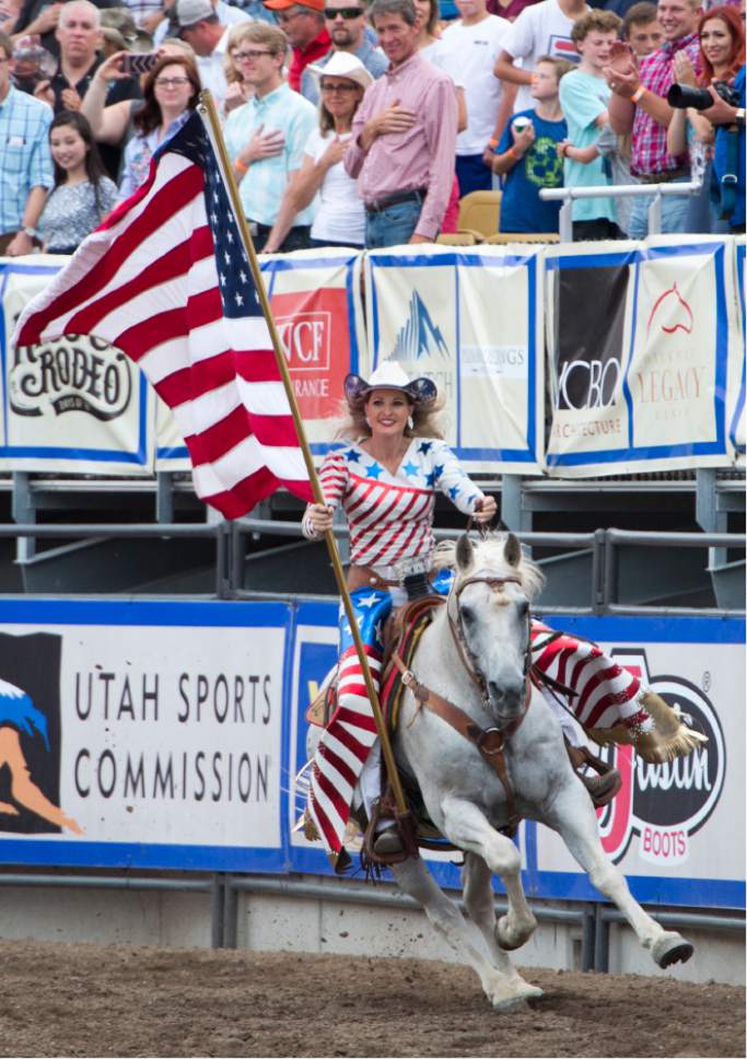 Rick Egan  |  The Salt Lake Tribune

Jessica Lott brings in the American Flag, at the opening of the Days of '47 Rodeo, Monday, July 24, 2017.