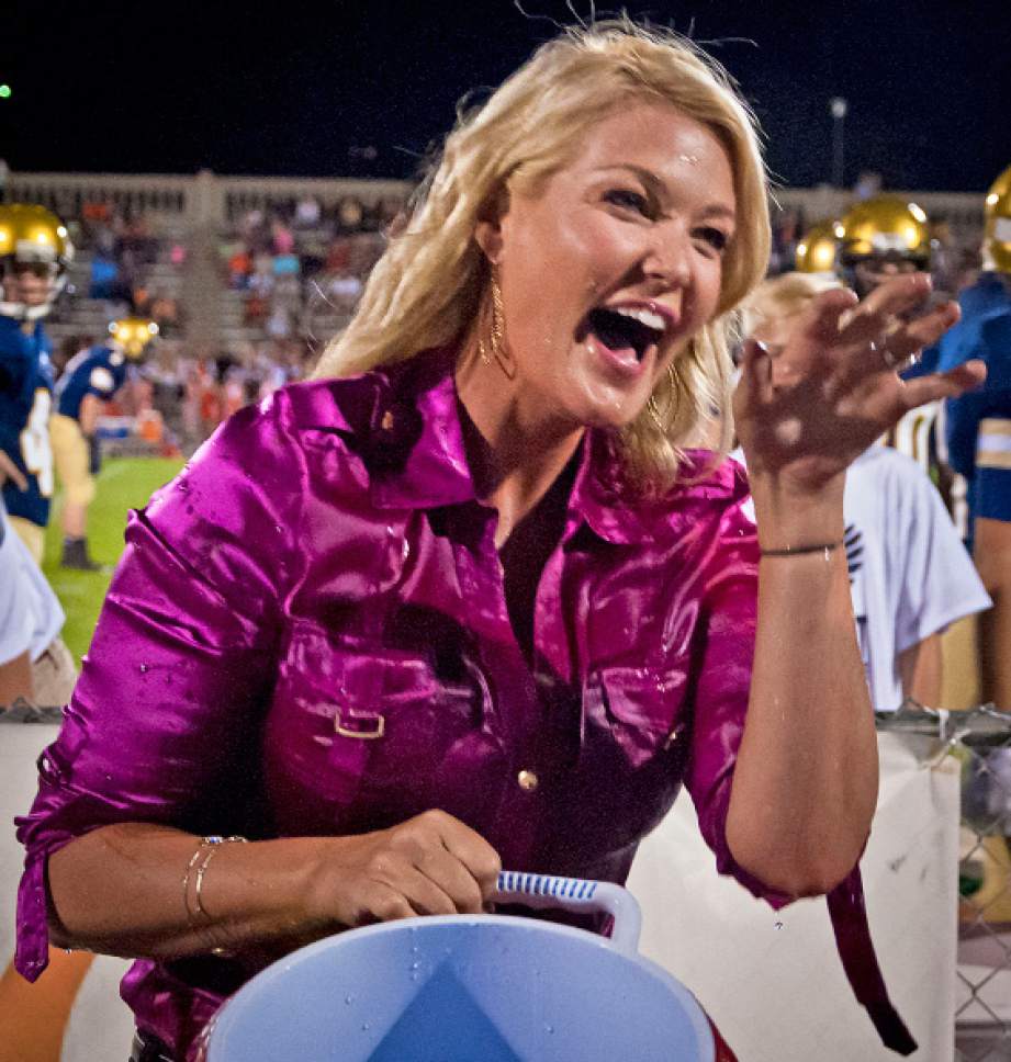 Michael Mangum  |  Special to The Salt Lake Tribune

KUTV 2News reporter Shauna Lake laughs with excitement after dumping a bucket of ice water over Tribune columnist Robert Kirby during halftime of the Homecoming football game at Skyline High School on Friday, September 19, 2014.