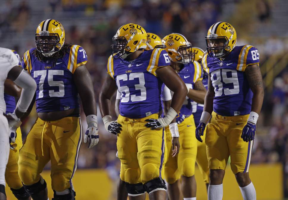 LSU offensive tackle Evan Washington (75), offensive linesman K.J. Malone (63) and tight end DeSean Smith (89)  line up for a play in the second half of an NCAA college football game against Louisiana Monroe in Baton Rouge, La., Saturday, Sept. 13, 2014. LSU won 31-0. (AP Photo/Gerald Herbert)