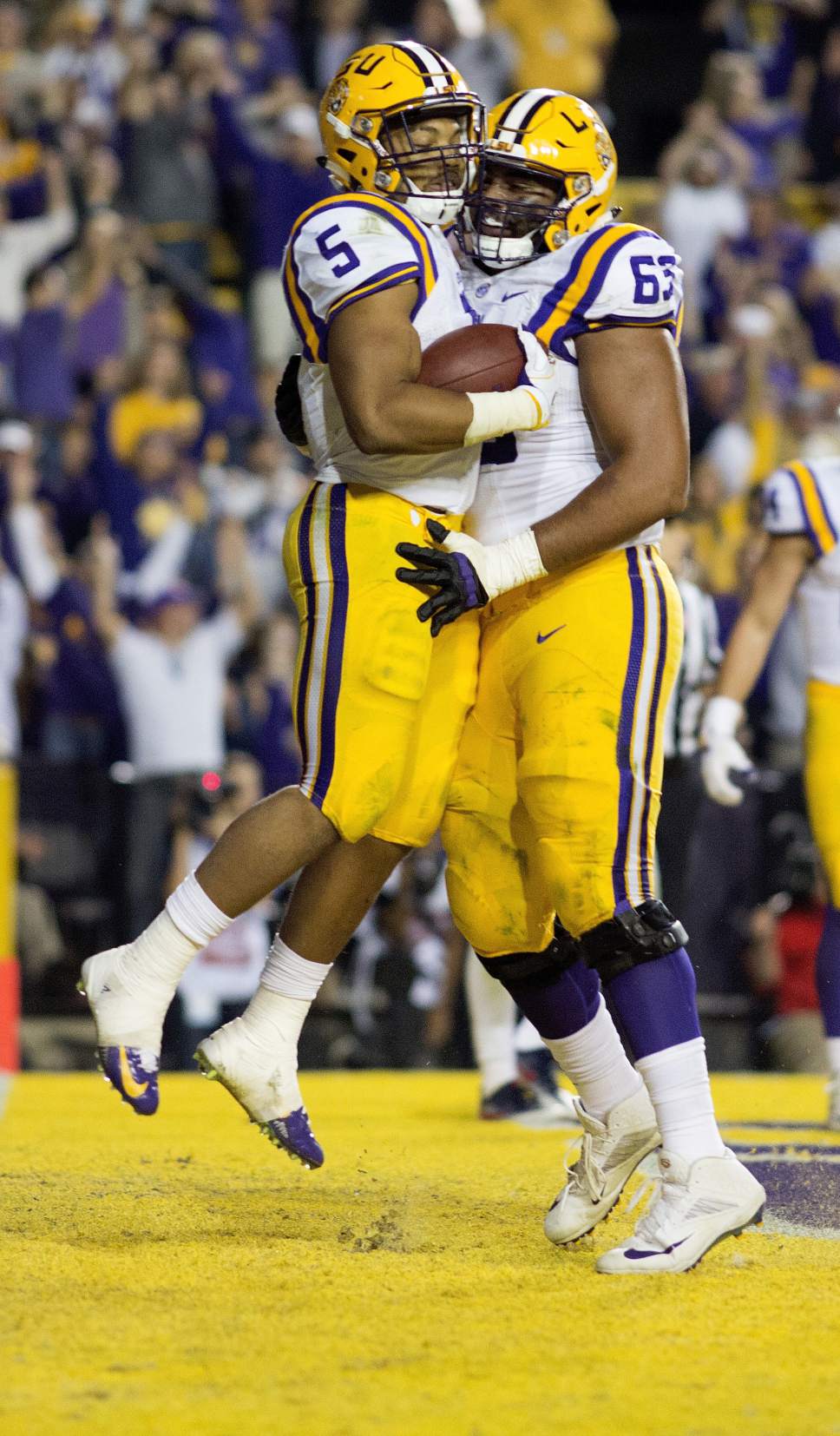 LSU running back Derrius Guice (5) celebrates a touchdown in the end zone with guard K.J. Malone (63) during the second half an NCAA college football game against Mississippi in Baton Rouge, La., Saturday, Oct. 22, 2016. LSU won 38-21. (AP Photo/Max Becherer)