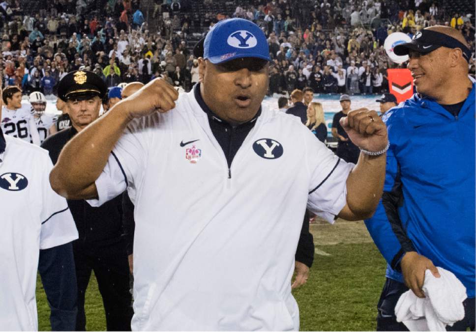 Rick Egan  |  The Salt Lake Tribune

Brigham Young Cougars head coach Kalani Sitake celebrates as he walks on to the field as BYU defeated Wyoming 24-21in the Poinsettia Bowl, at Qualcomm Stadium in San Diego, December 21, 2016.