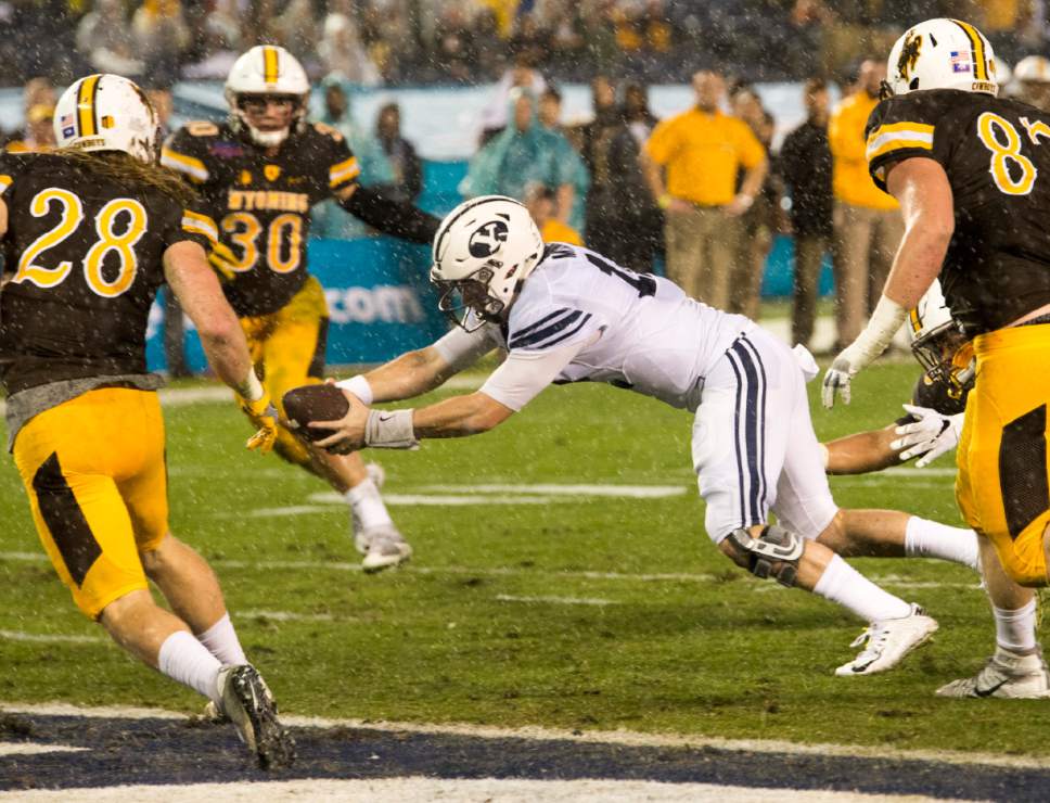 Rick Egan  |  The Salt Lake Tribune

Brigham Young Cougars Brigham Young Cougars quarterback Tanner Mangum (12) dives for a BYU touchdown, in the Poinsettia Bowl, at Qualcomm Stadium in San Diego, December 21, 2016.