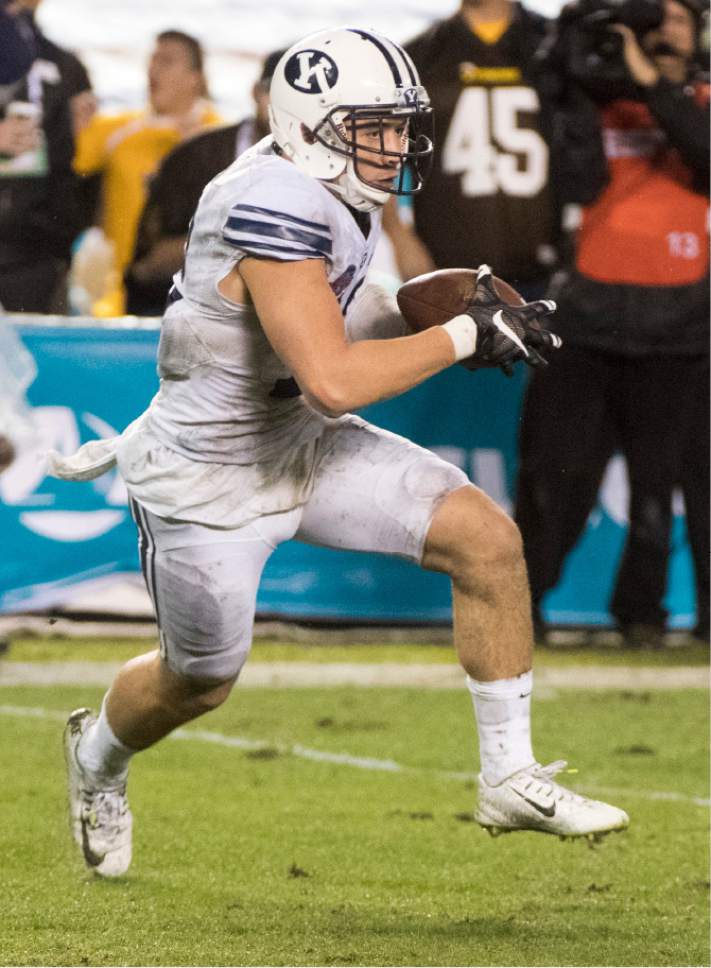 Rick Egan  |  The Salt Lake Tribune

Brigham Young defensive back Kai Nacua (12) runs with the ball after intercepting a pass thrown by Wyoming Cowboys quarterback Josh Allen (17) to win the game for the Cougars, as BYU defeated Wyoming 24-21in the Poinsettia Bowl, at Qualcomm Stadium in San Diego, December 21, 2016.