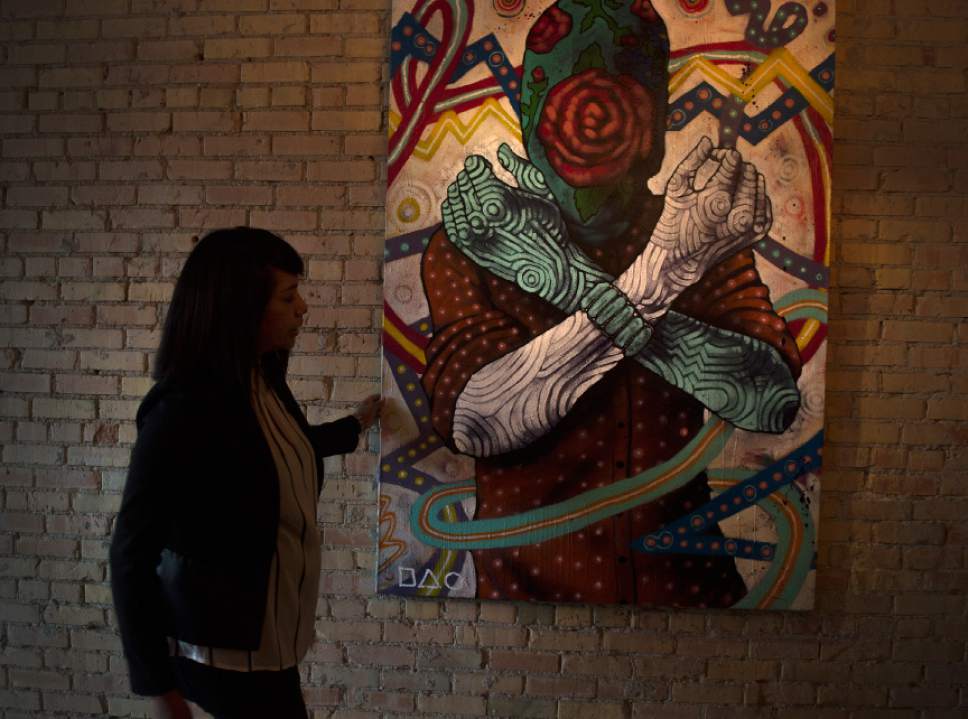 Leah Hogsten  |  The Salt Lake Tribune 
Black Sheep owner Bleu Adams straightens the work of Navajo artist Jeff Slim. Adams has been selected for the James Beard Foundation's first Women's Entrepreneurial Leadership Program.