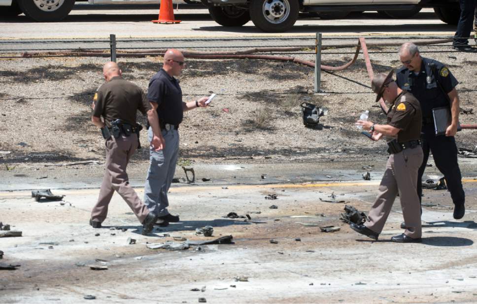 Rick Egan  |  The Salt Lake Tribune

Police sort through the debris from the plane crash that killed four people in the median of I-15 freeway, around 1:00pm. The crash closed the freeway to northbound traffic, Wednesday, July 26, 2017.